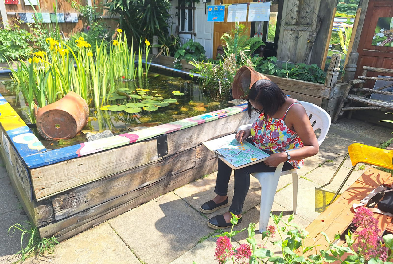 image of person drawing in the garden