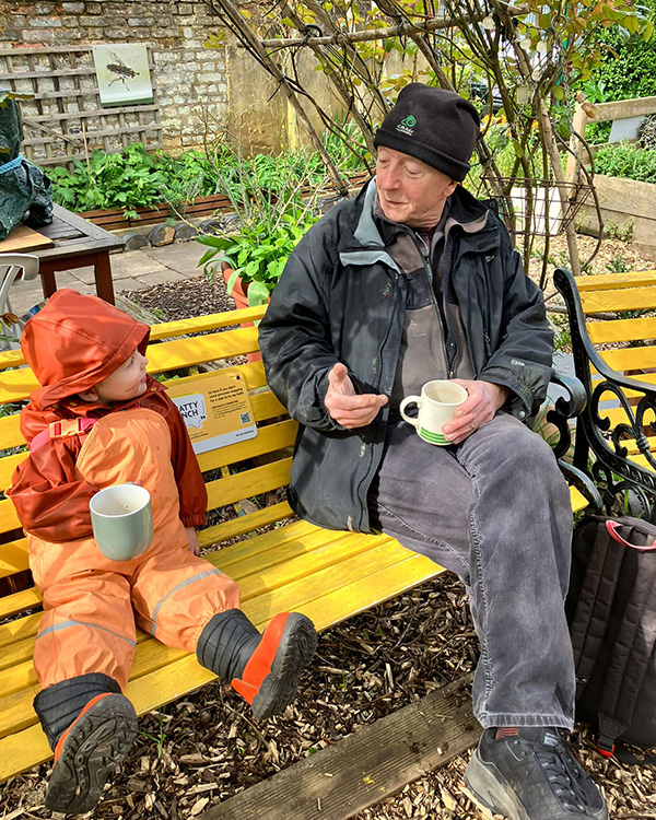 image of volunteer and young visitor on our chatty bench